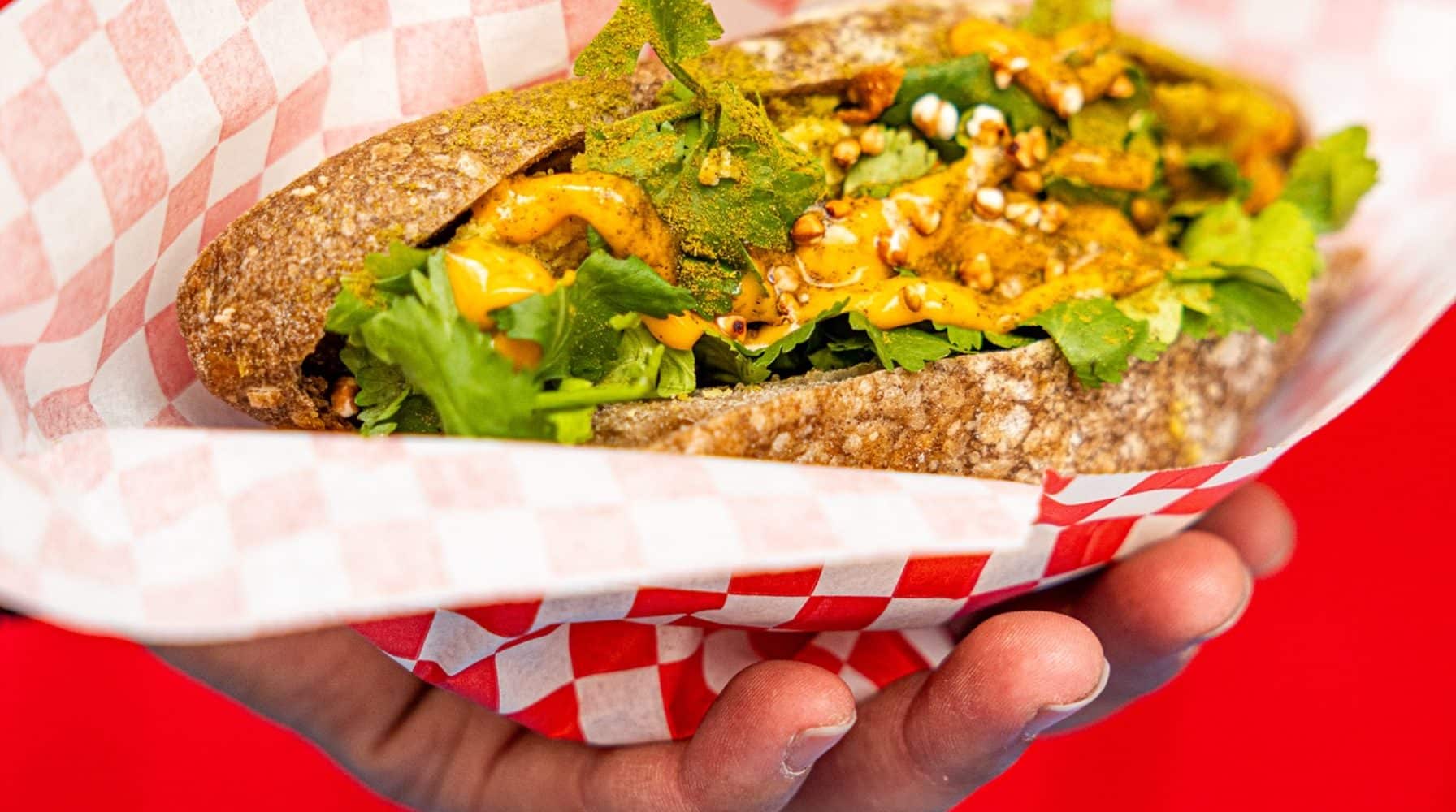 Sandwich au pain complet garni de légumes frais, servi lors d'un événement d'entreprise.